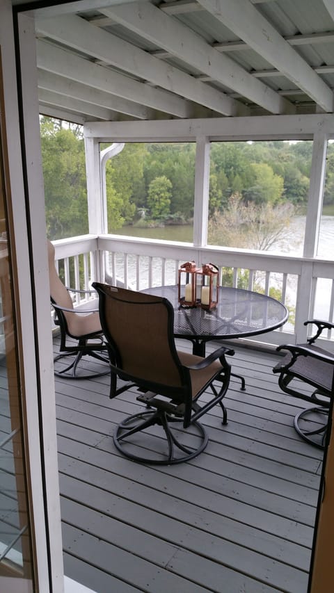 Lovely covered porch off of the kitchen for coffee or dinner overlooking lake