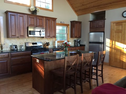 Fully equipped kitchen with seating for three at the island