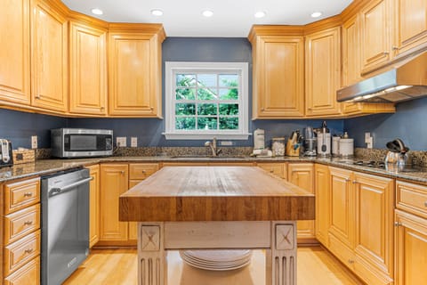 Full kitchen with view of pool, dual ovens, large refrigerator, microwave and coffee area