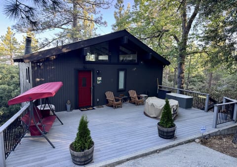 Relax on the deck, swing under the pines and enjoy the serenity of this hideaway