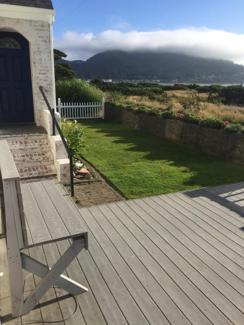 Outside deck with built-in benches, a fenced yard for kids/pets and music too.