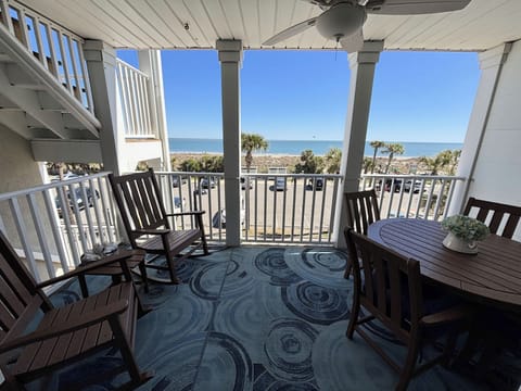 Relax in the rocking chairs , or sit at the table to enjoy the ocean view.