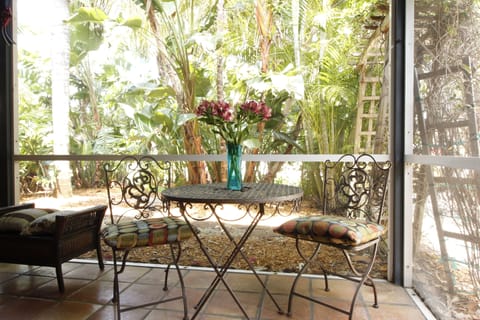 Sip your morning coffee or afternoon cocktails nestled into the tropical foliage
