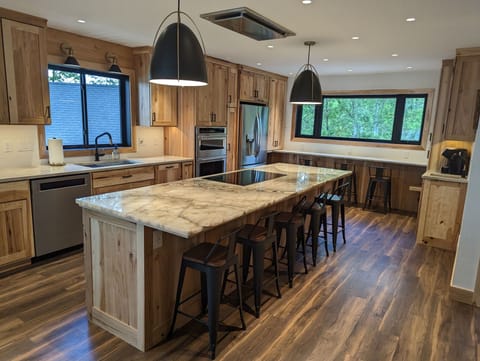 Large eat-in kitchen includes a coffee bar, seating at the island and window bar