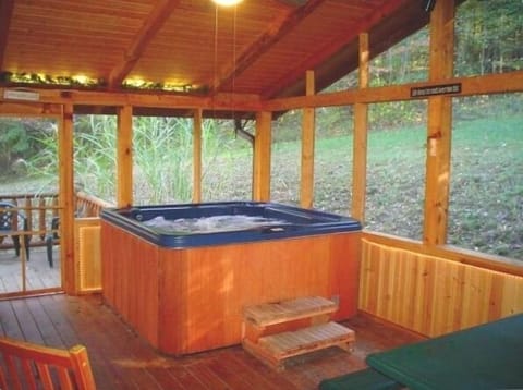 Private six person Hot Tub on screened and covered porch surrounded by woods.