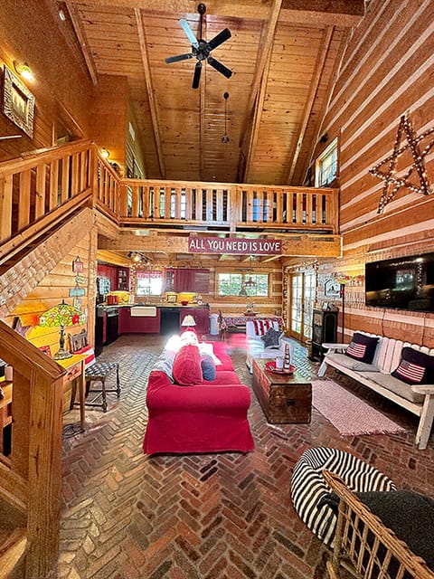 Welcome to the cabin! The Great Room offers group seating, TV, dining, back deck