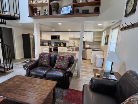 Living room and kitchen with vaulted ceilings and skylight