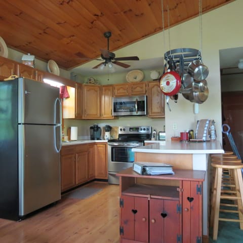 Kitchen with accessories...stainless steel appliances,  from dining room