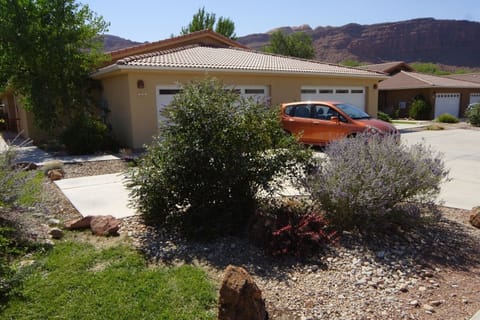 front yard showing two car garage and off street parking