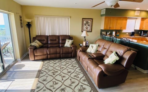 Living room with view into kitchen granite bar and bar stools