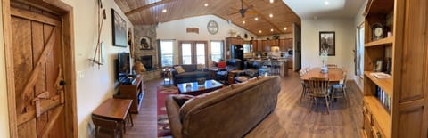 Panorama view of living area, kitchen, and dining areas.