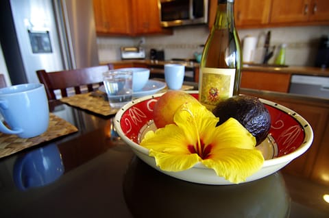 Local pineapple wine, fruit, and a flower from our lanai