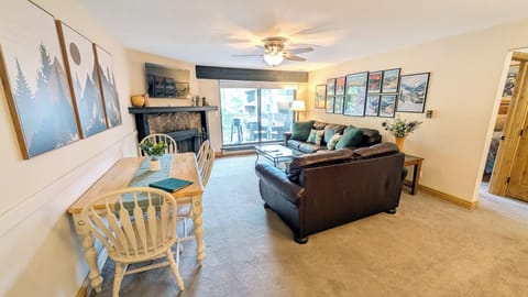 BC West J-3 Living room with wood fireplace and balcony w/ propane BBQ grill