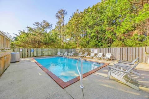 Dive into your private oasis surrounded by towering trees. Lounge poolside on comfortable chairs while nature's canopy provides peaceful shade.
