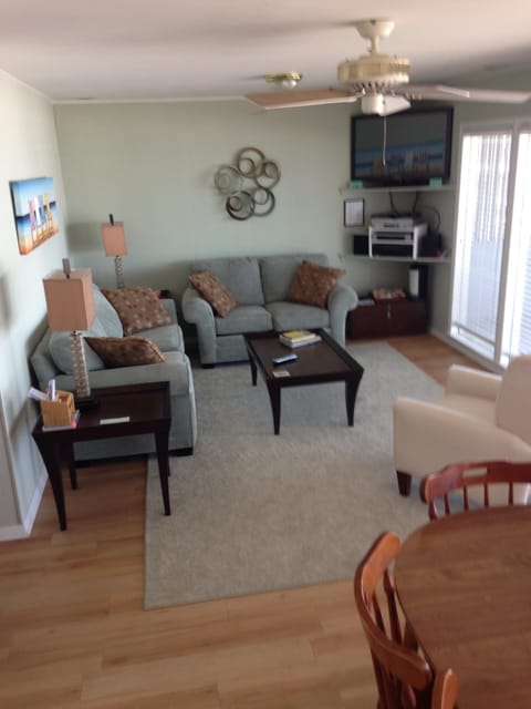 Oceanfront Living and dining area with large windows and view of the beach
