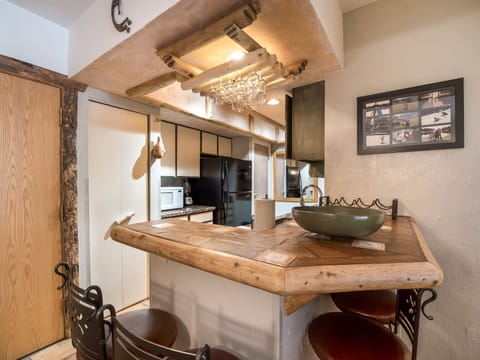 View of bar and kitchen.  Bar seats up to 4 people.