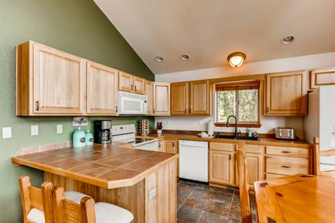 The spacious kitchen has custom tiled counter tops and everything you will need to prepare meals during your stay.