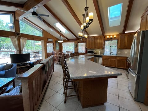 Kitchen with view of bar with seating for 6