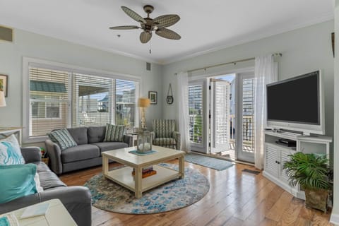 spacious living area that opens to furnished shaded deck