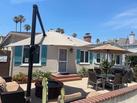 Relaxing south facing patio with natural gas firepit/bbq, table and umbrellas