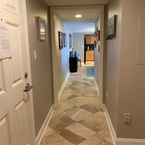 Hallway, flooring is stone.