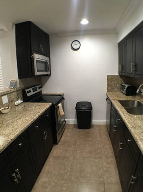 Vibrant and spacious kitchen with tile and marble finishes to compliment.