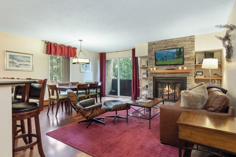 Open floor plan living room/dining room/kitchen w/ balcony and view of mountain!
