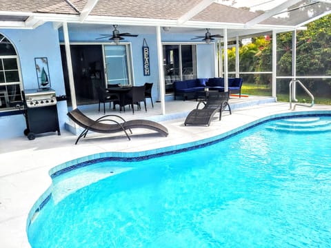 .Heated pool with outdoor seating for lounging and eating . 