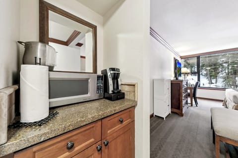 Mini fridge w/small freezer inside cabinet below microwave & keurig coffee pot