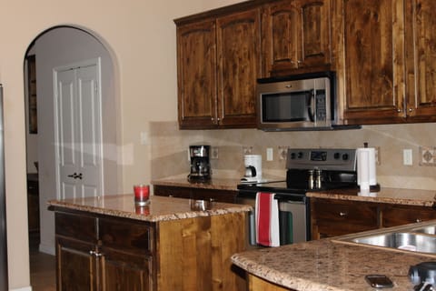 Kitchen has all stainless steel appliances and granite countertops