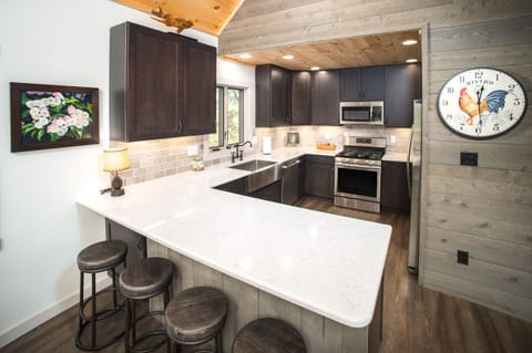 another view of cook's kitchen and counter top seating