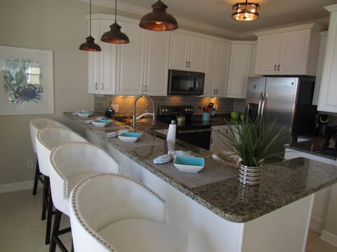 full kitchen with granite countertops and stainless steel appliances