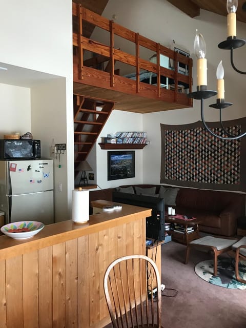 Living area and kitchen from dining area.  Loft is above 
