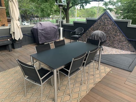 garage rooftop deck with grill and fire pit.