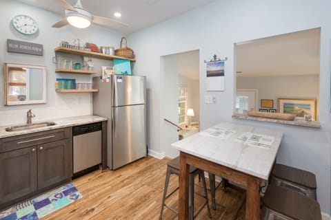 Pass-though window between kitchen and living.  Island on wheels for eating together or for use as counter space for preparing meals.