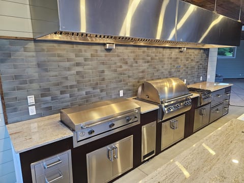 Outdoor chefs kitchen with top of the line appliances and refrigeration