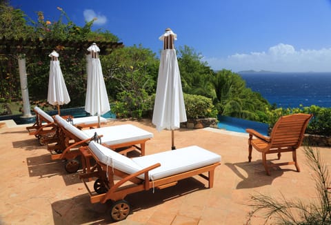 Gaze over Mustique, Baliceaux and Batawai islands from the shaded pool deck.