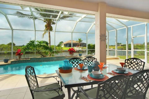 Enjoy your meals poolside with the dining area for 6