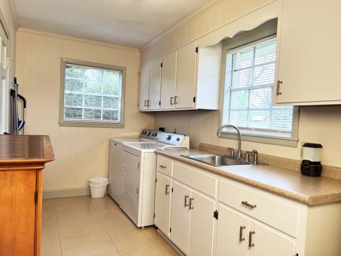 Utility Room provides a new washer/dryer, vacuums, brooms, dust pans and mops.