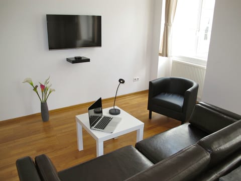 Living area with our 42' TV and a single round designer coutch