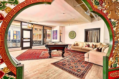 Sun-Filled Gallery Loft Living Room with Large Sofa & Pool Table