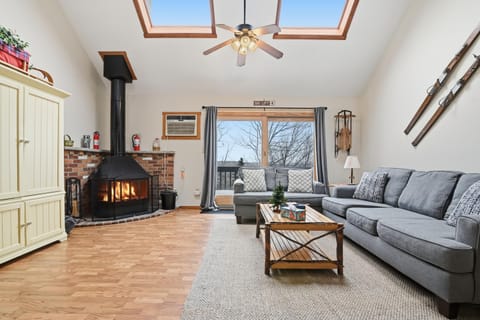 Living room.  2 couches, fireplace, back deck w/grill.  TV located in armoire. 