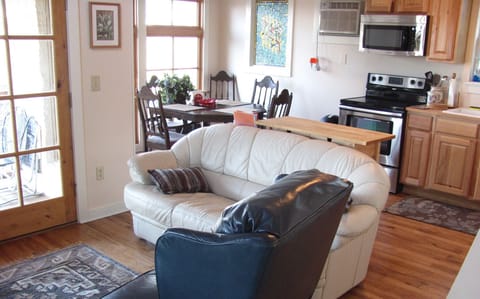 Living area with dining and kitchen in rear of photo