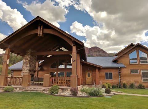 Massive outdoor living porch has woodburning fireplace, sitting area, 14' table.