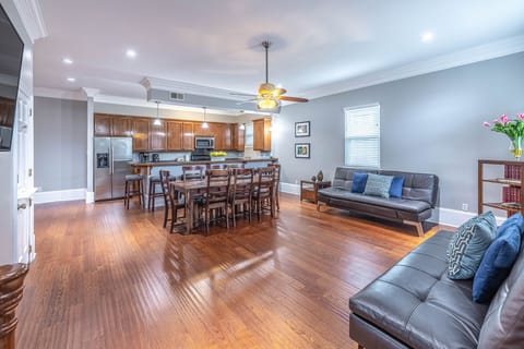 Interior view of the open floor plan to include 8 dining table, two Euro sofas 