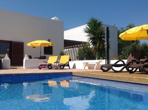 View of the villa, garage, terrace and solar heated , salt water pool 
