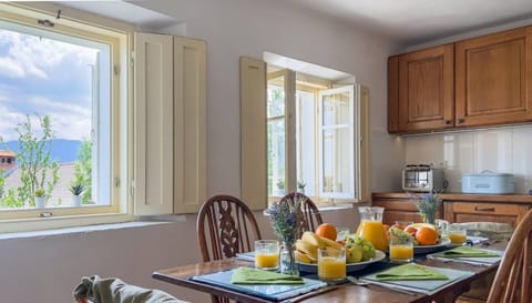 The bright and airy kitchen, is well equipped and has a dining table to seat six. 