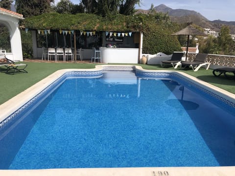 Our fantastic pool with the Tiki bar and mountain view in the background.