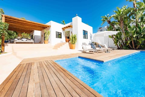 Modern Villa with outside pool area and covered seating area 

