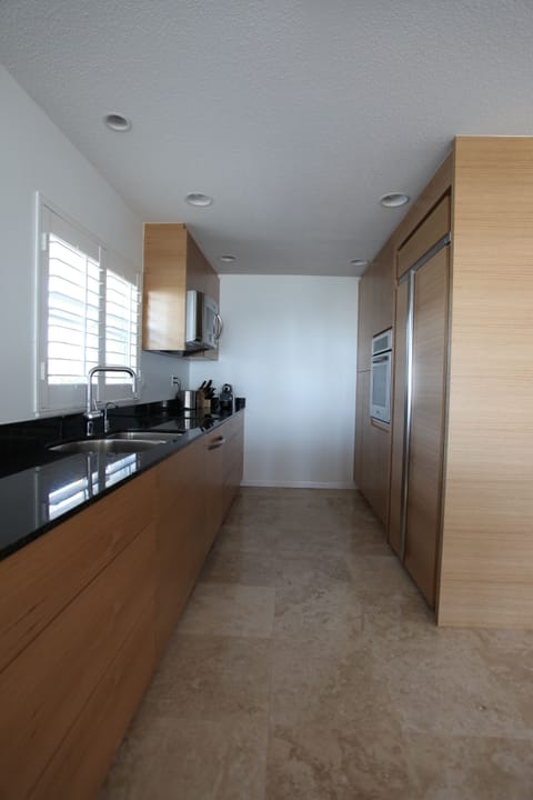 Contemporary gripless kitchen with a-grade appliances.